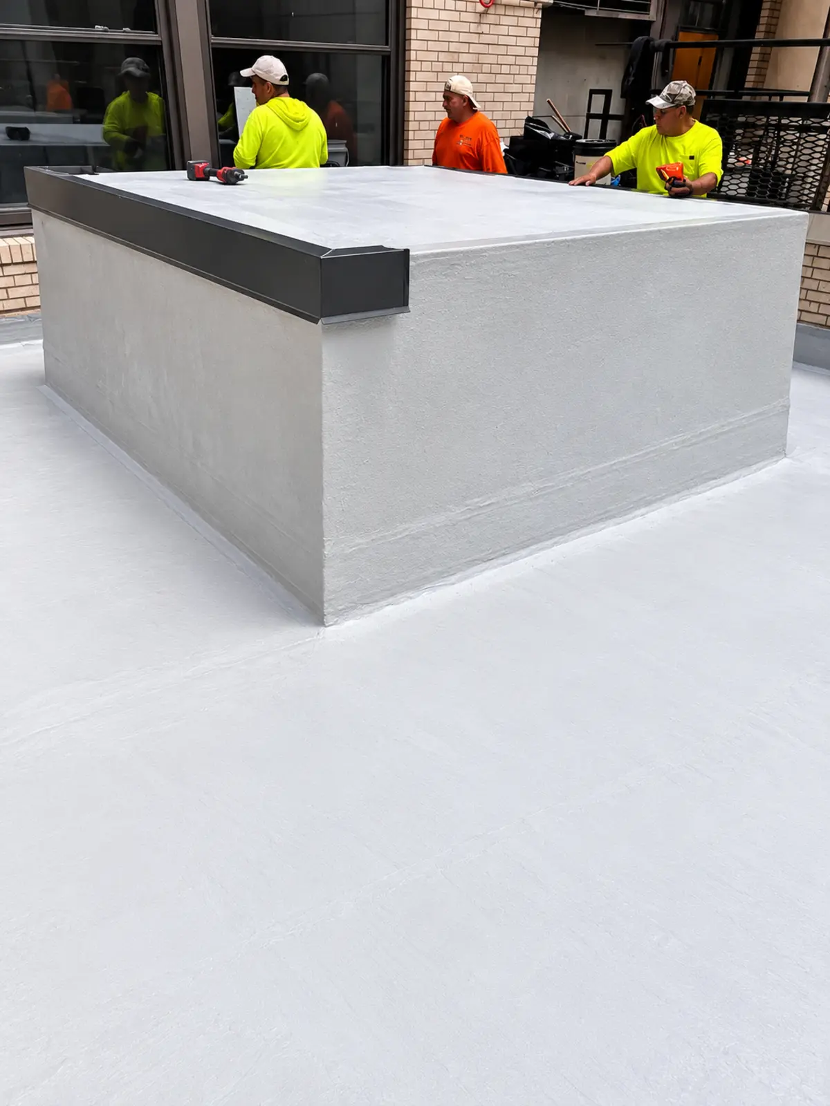 GVA crew completing the waterproofed courtyard surface