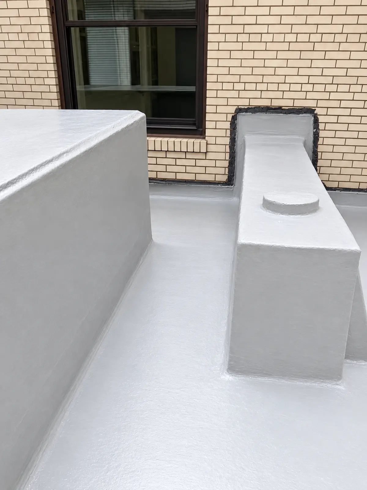 Completed waterproofing detail around courtyard structures