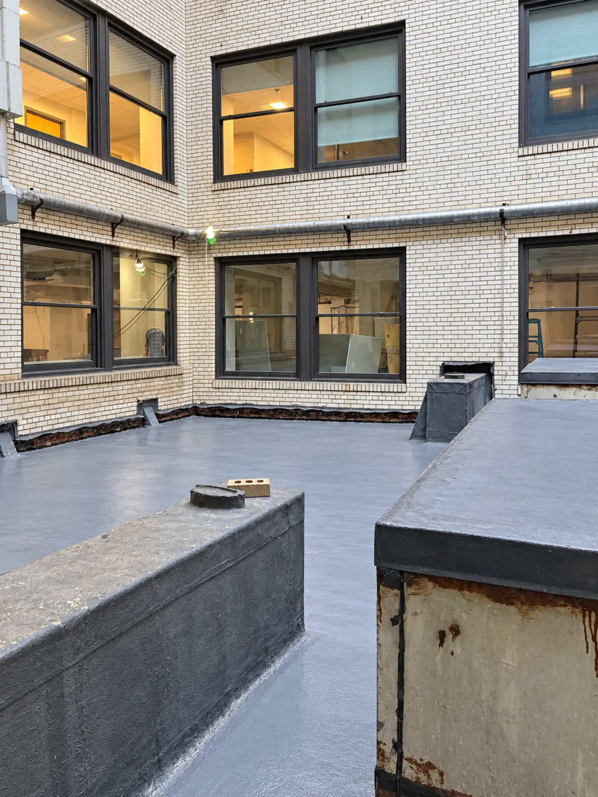 Detailed courtyard waterproofing installation in progress