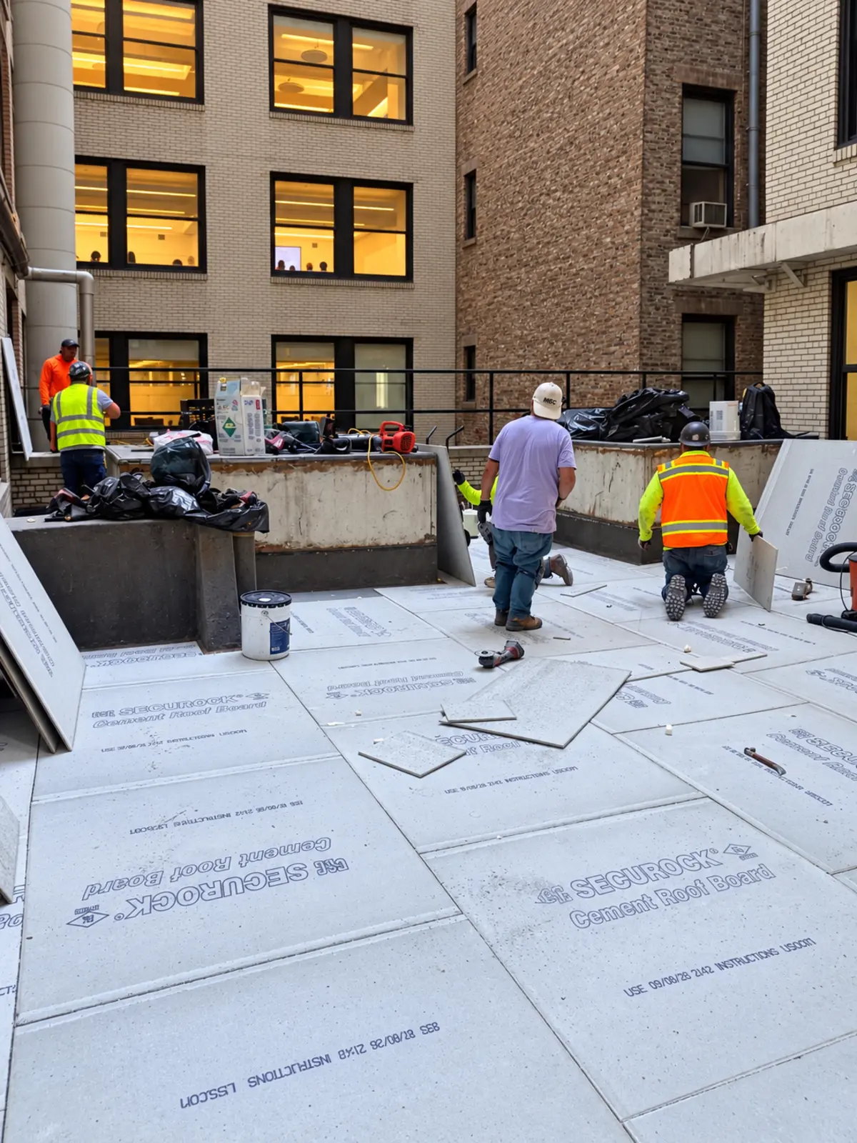 GVA crew installing courtyard insulation during renovation