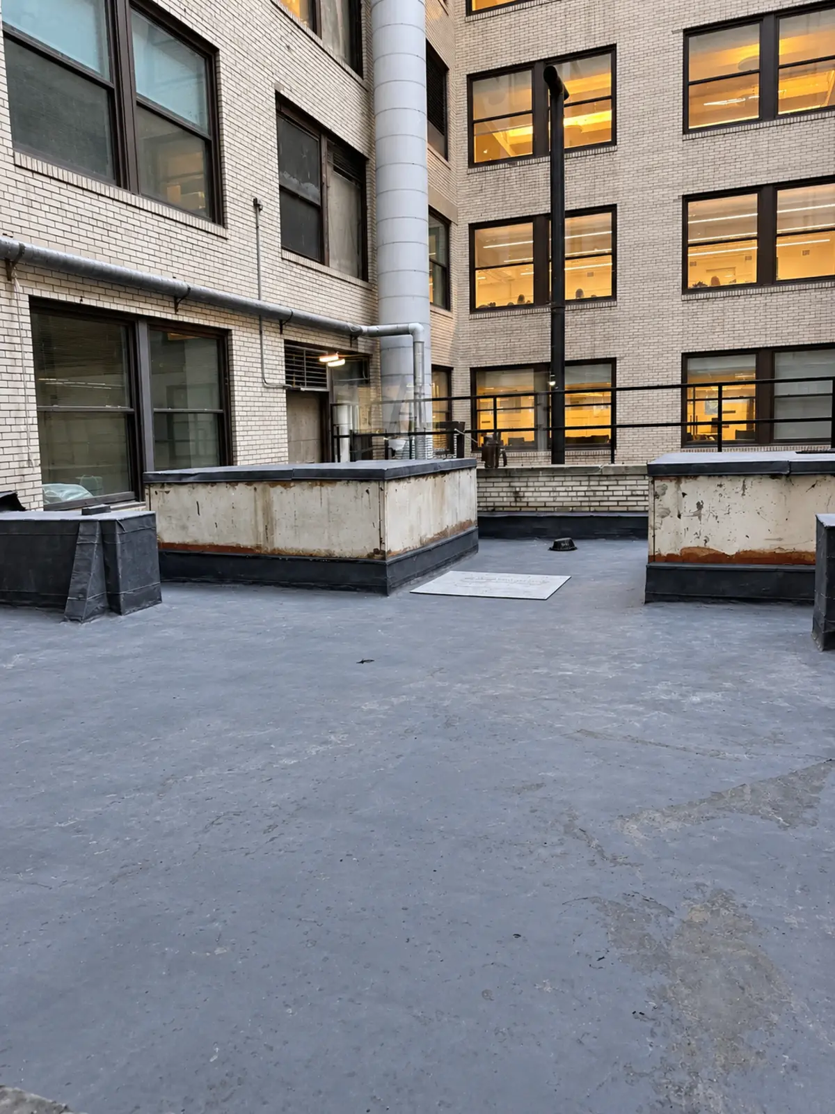 Wide view of courtyard waterproofing work in progress